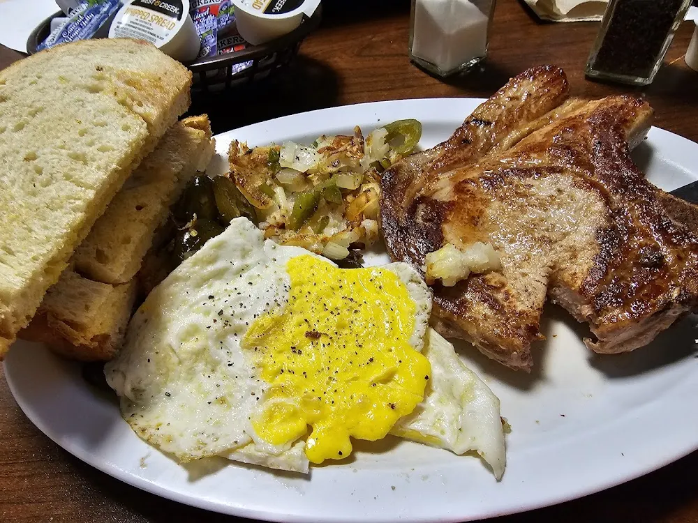 Breakfast Special Porkchop Eggs Fried Potatoes and Toast